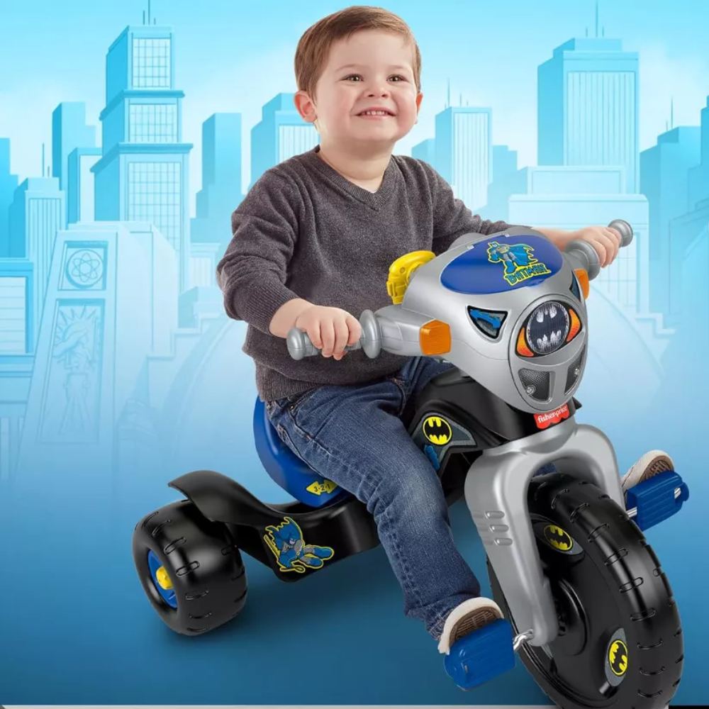 Fisher-Price Toddler Tricycle DC Super Friends Batman Lights & Sounds Trike. This trike lights up and plays action-packed sounds to enhance the fun. It also comes with a toy walkie-talkie that features voice lines from Batman himself. HCF39 thumbnail
